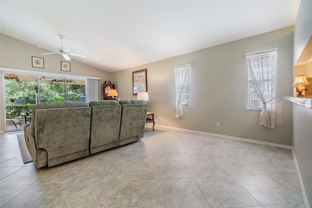 tiled living room with plenty of natural light, ceiling fan, and vaulted ceiling