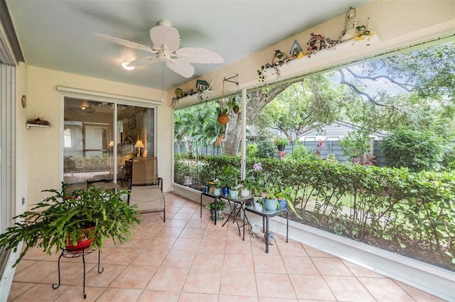 sunroom / solarium featuring ceiling fan