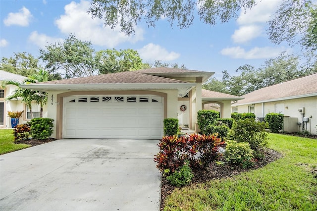 view of front of home featuring a front yard and a garage