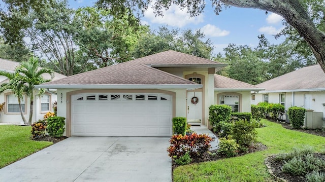 view of front of house with a garage and a front lawn