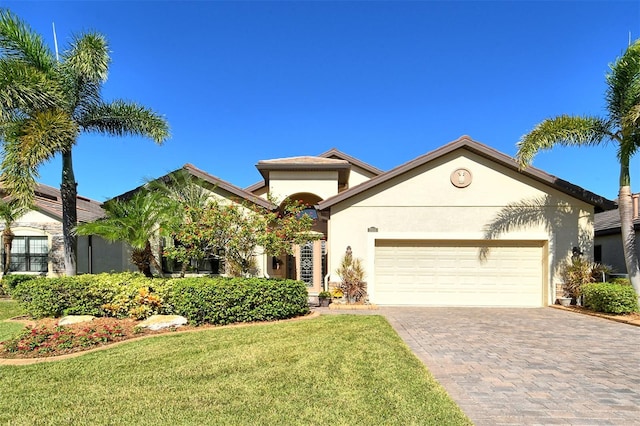 view of front of property with a garage and a front yard