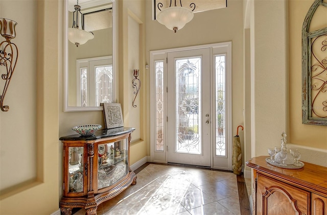 foyer entrance with plenty of natural light and light tile patterned flooring