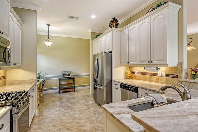 kitchen featuring white cabinetry, sink, light stone counters, pendant lighting, and appliances with stainless steel finishes