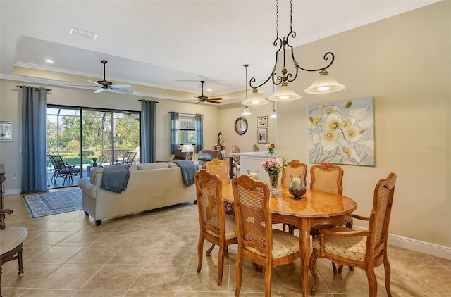 tiled dining space featuring ceiling fan with notable chandelier and ornamental molding