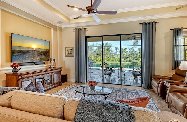 tiled living room with crown molding, ceiling fan, and a healthy amount of sunlight