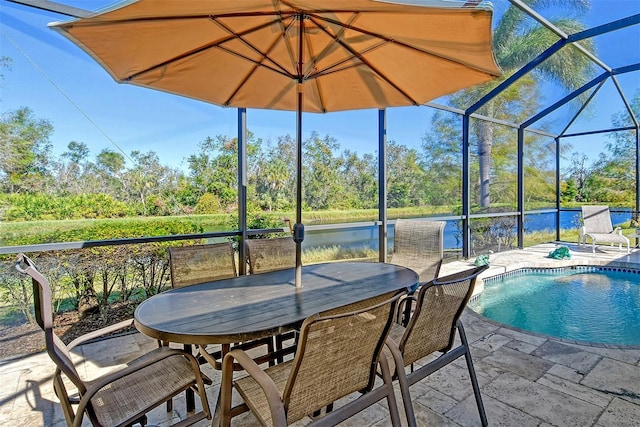 view of pool featuring a water view, a lanai, and a patio area