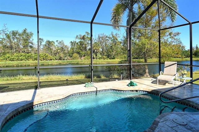 view of swimming pool with glass enclosure, a water view, and a patio