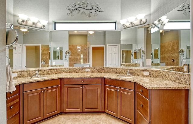 bathroom featuring tile patterned floors, ceiling fan, walk in shower, and vanity