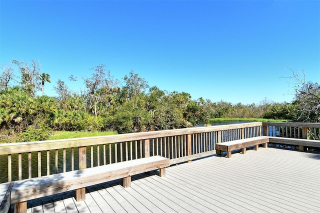 wooden deck featuring a water view