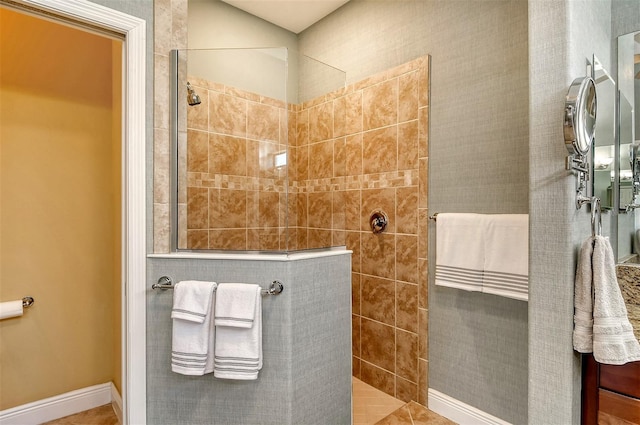 bathroom with tile patterned flooring and tiled shower