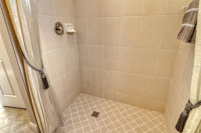 bathroom with tile patterned floors and curtained shower