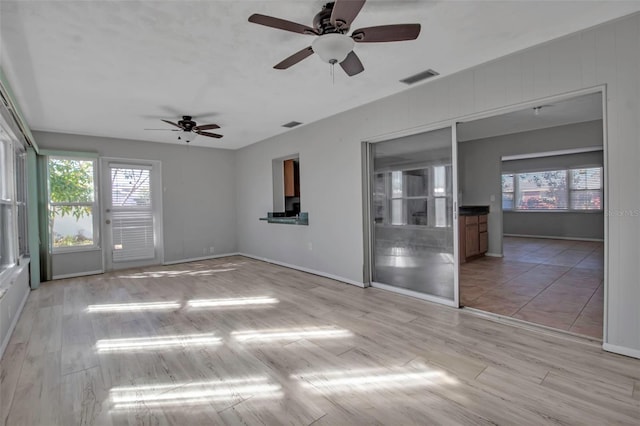 empty room with light hardwood / wood-style floors and ceiling fan