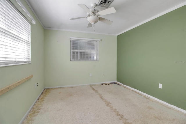 empty room with ceiling fan, light colored carpet, and crown molding