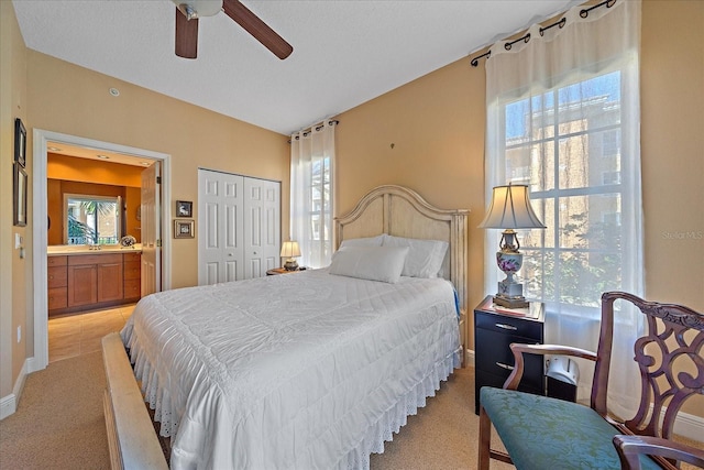 carpeted bedroom featuring a closet and ceiling fan