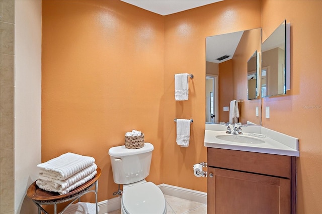 bathroom featuring tile patterned flooring, vanity, and toilet