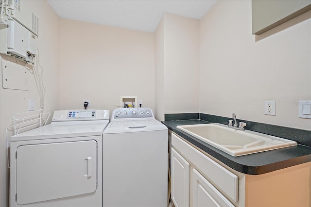 laundry room featuring cabinets, sink, and washer and dryer