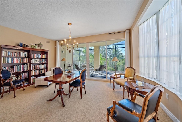 office featuring carpet floors, a chandelier, and a textured ceiling