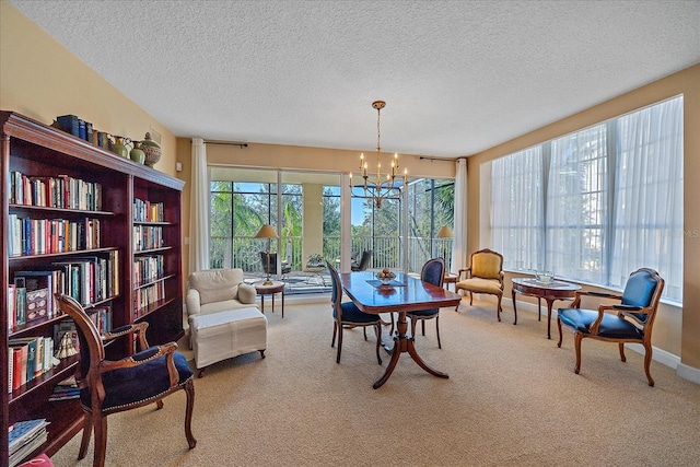 living area featuring carpet floors, a chandelier, and a textured ceiling