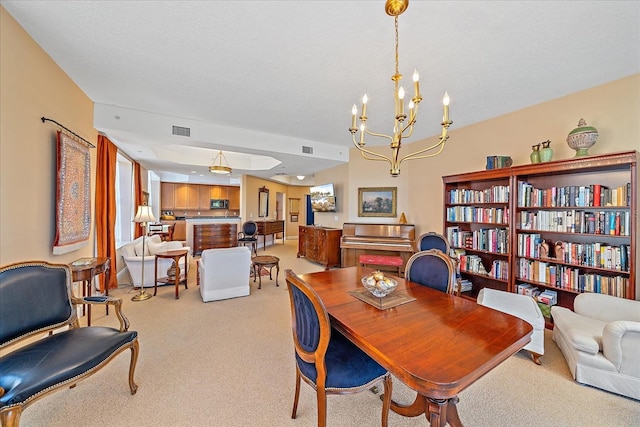 dining space featuring a notable chandelier, light colored carpet, and a textured ceiling