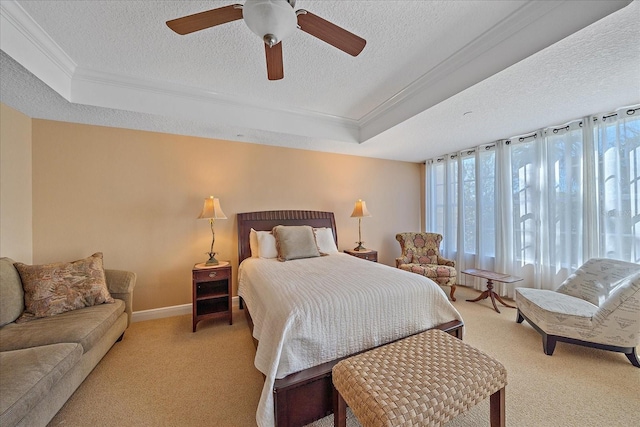 bedroom with a tray ceiling, ceiling fan, light colored carpet, and a textured ceiling