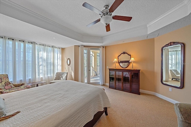 carpeted bedroom with access to exterior, ceiling fan, a raised ceiling, a textured ceiling, and ornamental molding