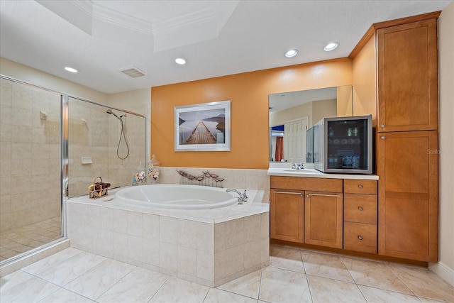 bathroom featuring tile patterned floors, crown molding, vanity, and shower with separate bathtub