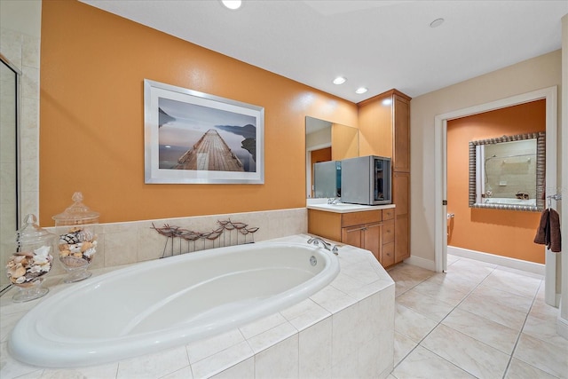 bathroom featuring vanity and independent shower and bath