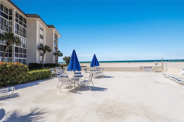 view of patio featuring a water view and a view of the beach