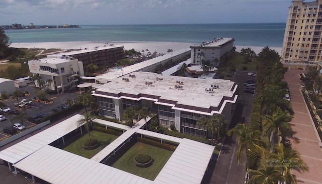 drone / aerial view featuring a water view and a beach view