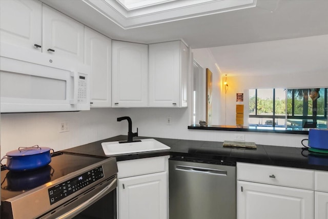 kitchen with white cabinets, sink, and appliances with stainless steel finishes