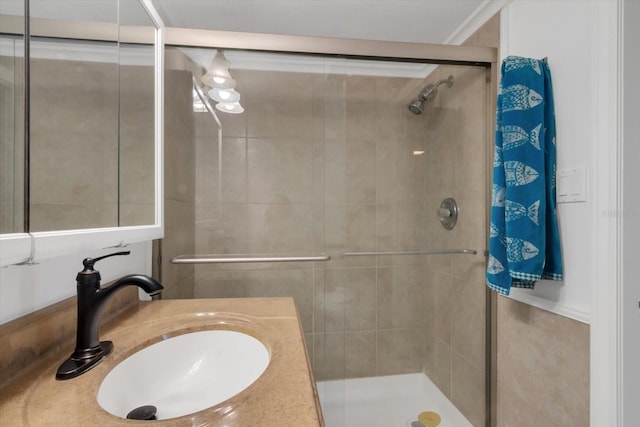 bathroom with vanity, ornamental molding, and walk in shower