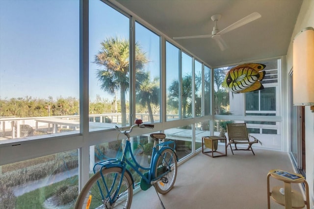 sunroom featuring ceiling fan and a wealth of natural light