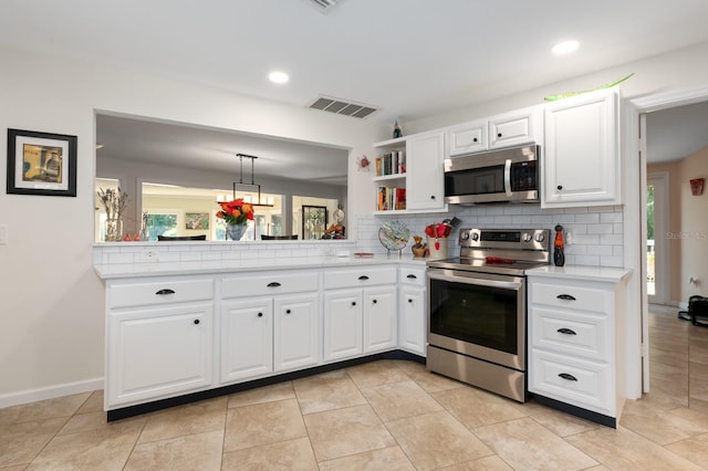 kitchen featuring tasteful backsplash, plenty of natural light, white cabinets, and stainless steel appliances