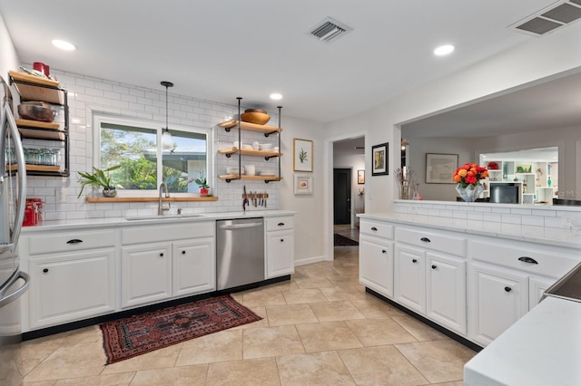 kitchen with white cabinets, dishwasher, sink, and tasteful backsplash