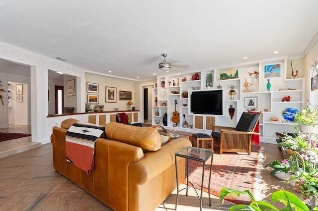 living room featuring a textured ceiling, ceiling fan, and crown molding