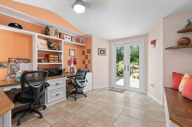 tiled office space featuring french doors, built in desk, and lofted ceiling