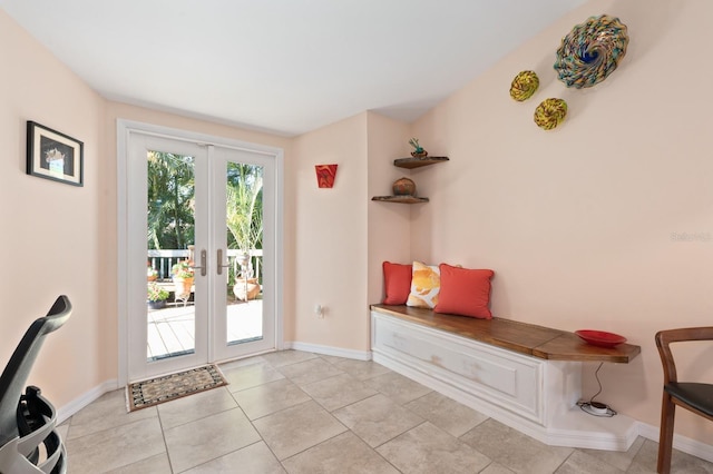 interior space with light tile patterned floors and french doors