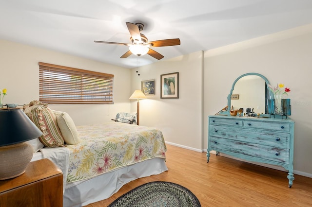 bedroom with ceiling fan and light hardwood / wood-style floors