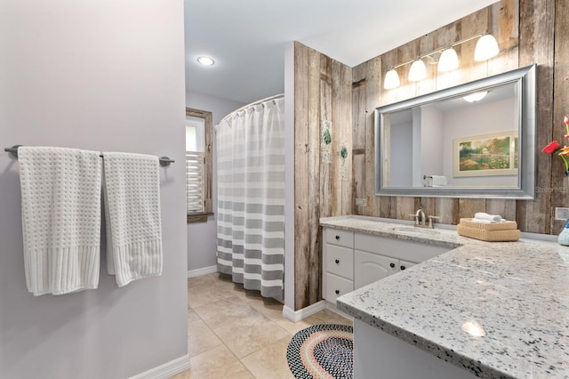 bathroom featuring curtained shower, wood walls, tile patterned flooring, and vanity