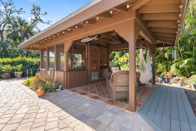 view of patio / terrace featuring a sunroom