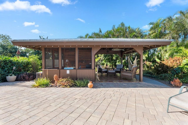 view of patio featuring a sunroom