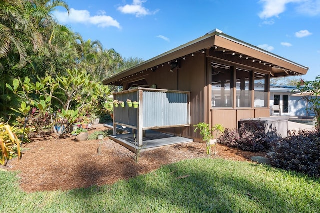 view of property exterior featuring a sunroom