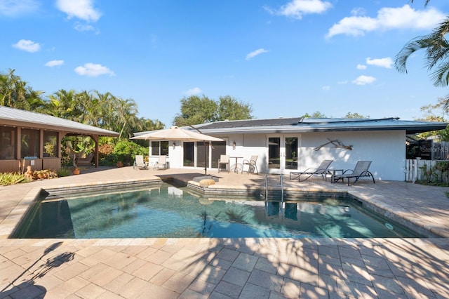 view of swimming pool featuring french doors and a patio