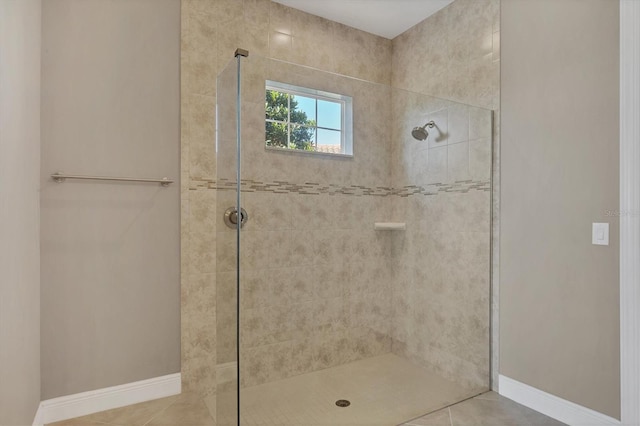 bathroom with tile patterned flooring and tiled shower