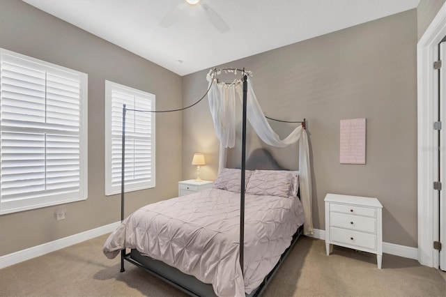 bedroom with ceiling fan and light carpet