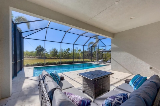 view of pool with an outdoor hangout area, glass enclosure, and a patio area