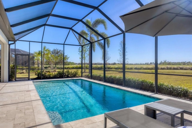 view of pool featuring glass enclosure and a patio area