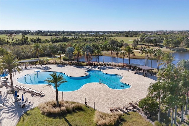 view of pool with a patio area and a water view