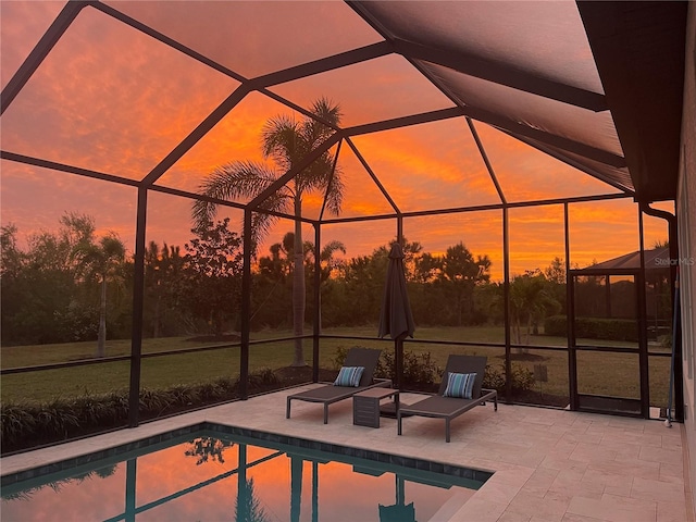 pool with a lanai and a patio area