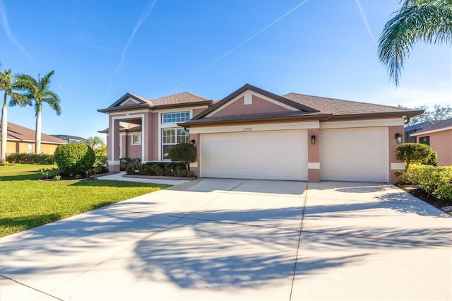 view of front of property featuring a front yard and a garage